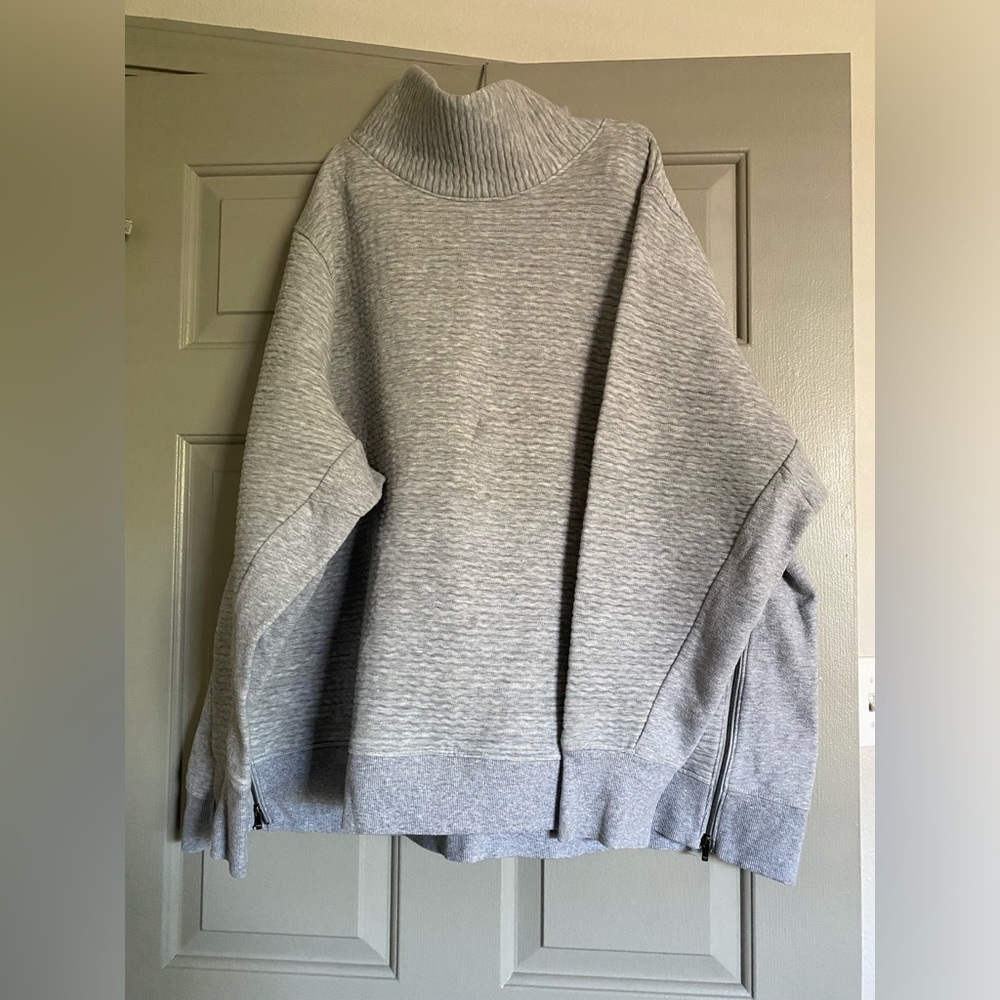 All in motion, gray sweater
